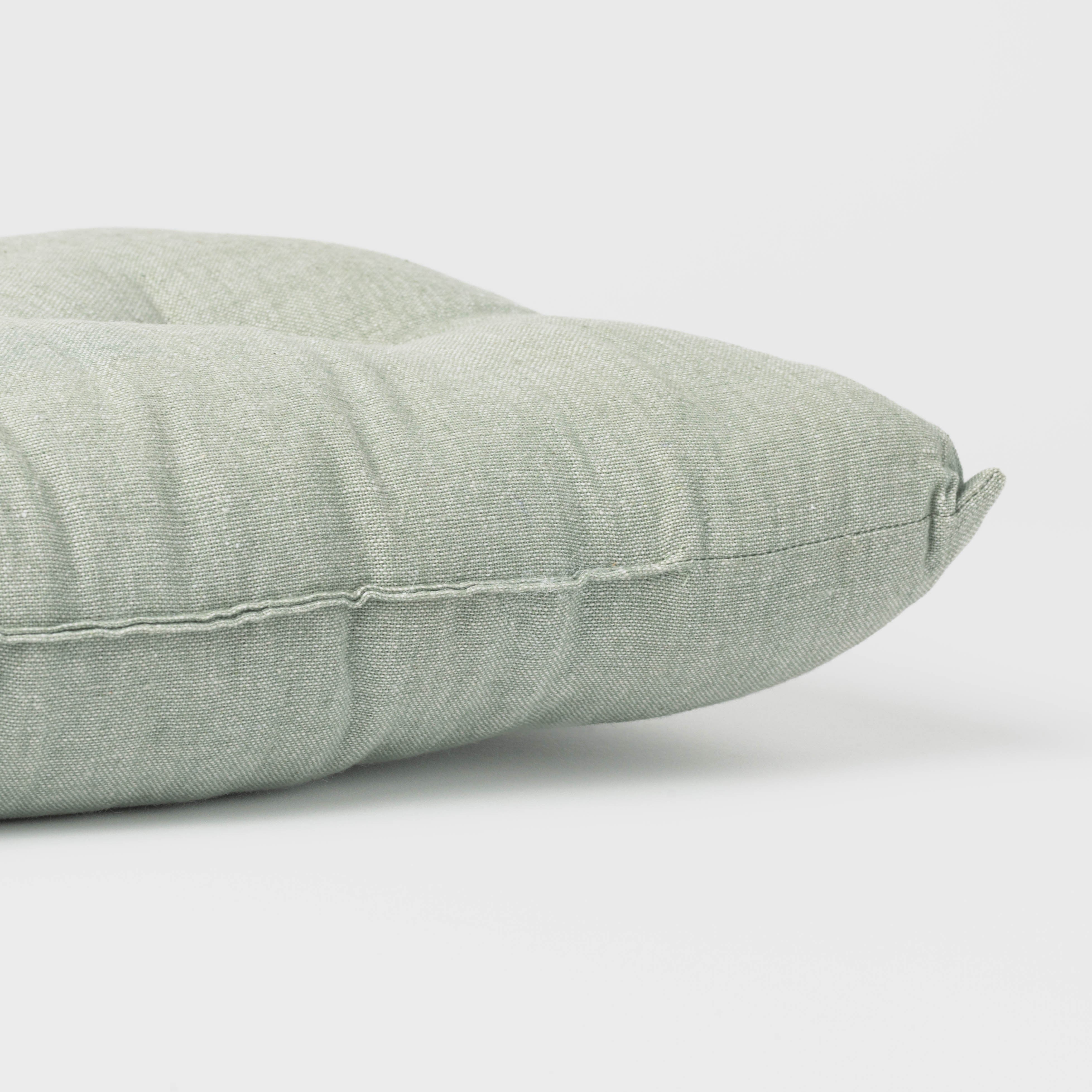 Almofada de algodão simples com botões e ferro de passar.